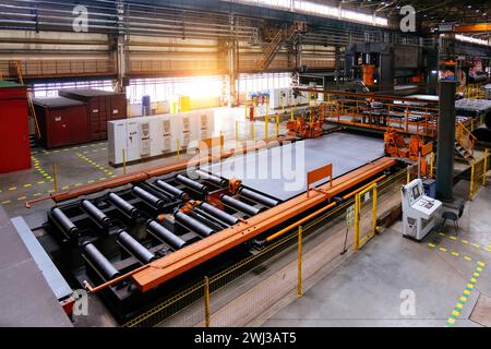 Ligne de production d'usine de tuyaux. Formation de tubes par machine à cintrer des feuilles à rouleaux. Banque D'Images