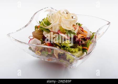 Salade de radis dans un bol en verre isolé sur blanc Banque D'Images