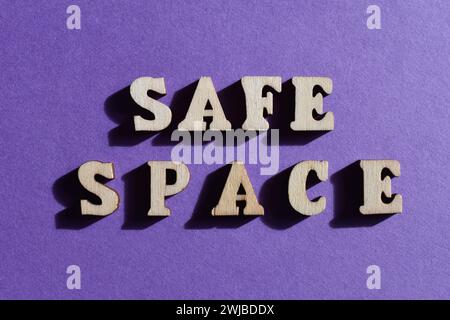 Safe Space, mots en lettres de l'alphabet en bois isolés sur fond violet Banque D'Images