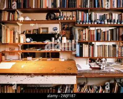 L'auteur et artiste Alasdair Gray, auteur du livre Poor Things à la maison dans son studio de travail salon, entouré de livres et de pots de peinture Banque D'Images