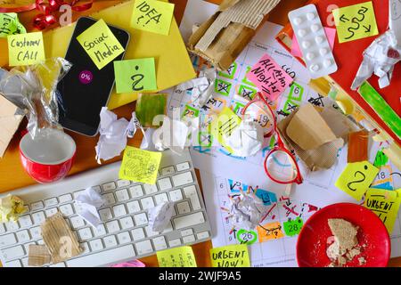 Lieu de travail désordonné, bureau chaotique, surmenagé, burnout, mobbing, bureaucratie, concept de paperasse avec bureau grungy, notes adhésives et diverses fournitures de bureau, un Banque D'Images