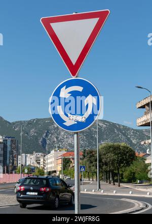 Rond-point ou panneau rotatif en dessous du panneau de céder la place ou de céder sur le même poteau dans la zone urbaine Banque D'Images