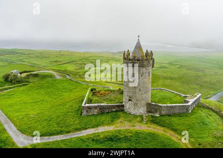 Vue aérienne du château de Doonagore, tour ronde du XVIe siècle avec une petite enceinte murée située près du village côtier de Doolin dans le comté de CLA Banque D'Images