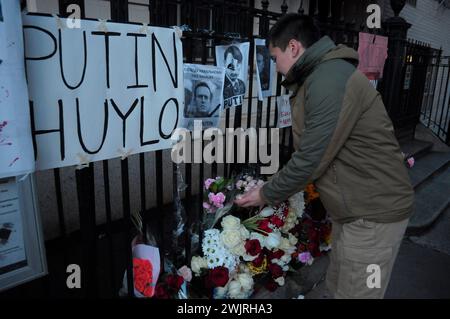 New York, États-Unis. 16 février 2024. Un démonstrateur place des fleurs lors d'une veillée pour Alexei Navalny. La veillée a eu lieu devant le consulat général de la Fédération de Russie dans l'arrondissement de Manhattan à New York. Selon un rapport du service pénitentiaire russe, Alexei Navalny, ancien avocat et critique de Vladimir Poutine, est mort en prison dans une colonie pénitentiaire russe au nord du cercle arctique. Le président américain Joe Biden a blâmé Poutine pour la mort de Navalny. Navalny purgeait une peine combinée de plus de 30 ans de prison. Crédit : SOPA images Limited/Alamy Live News Banque D'Images