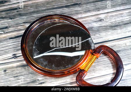 Miroir à main cassé, verre de miroir fissuré, écrasé endommagé, un miroir est un objet qui reflète une image, également appelé verre de regard, miroir inversé Banque D'Images