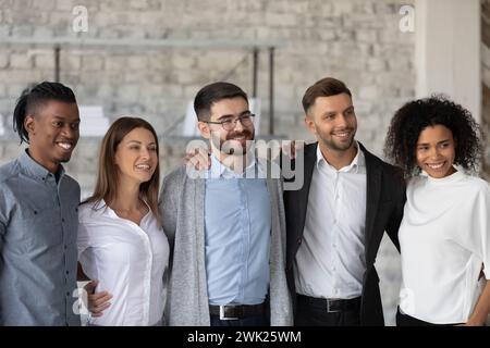 Jeunes collègues heureux posant pour une photo de groupe au bureau Banque D'Images