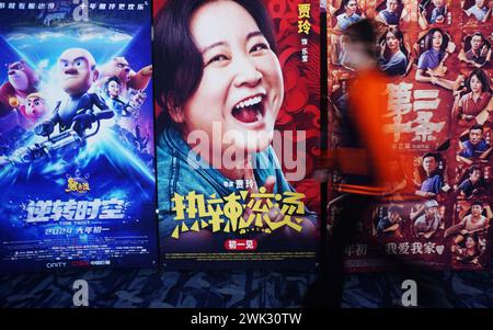 Pékin, province chinoise du Zhejiang. 16 février 2024. Un citoyen passe devant des affiches de cinéma dans un cinéma de la ville de Hangzhou, dans la province du Zhejiang de l'est de la Chine, le 16 février 2024. Crédit : long Wei/Xinhua/Alamy Live News Banque D'Images