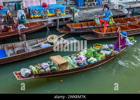 Vendeurs thaïlandais sur leurs bateaux dans le Damnoen Saduak Floating Market en Thaïlande. Banque D'Images