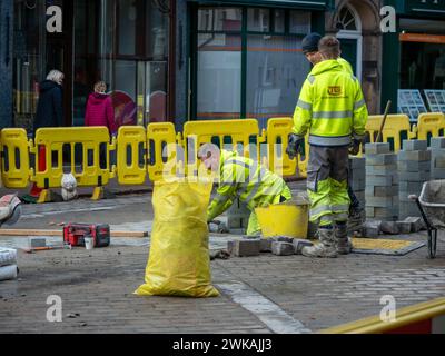 Des ouvriers vêtus de vêtements de haute qualité travaillent sur le renouvellement de l'infrastructure des conduites de gaz sur Stricklandgate, A6 dans le centre historique de la ville de marché. Banque D'Images