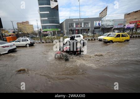 Peshawar, Peshawar, Pakistan. 19 février 2024. Des tempêtes de pluie ont frappé la ville pakistanaise de PeshawarPESHAWAR, PAKISTAN, 17 FÉVRIER : des gens tentent de déplacer une route inondée après que des tempêtes de pluie ont frappé la ville pakistanaise de Peshawar le 17 février. (Crédit image : © Hussain Ali/ZUMA Press Wire) USAGE ÉDITORIAL SEULEMENT! Non destiné à UN USAGE commercial ! Crédit : ZUMA Press, Inc/Alamy Live News Banque D'Images