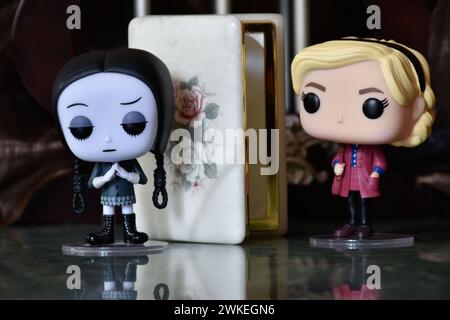 Funko Pop figurines de mercredi Addams et Sabrina Spellman sorcière. Colonnes, sombre, crypte, cercueil blanc ouvert, effrayant, gothique, plancher de réflexion. Banque D'Images