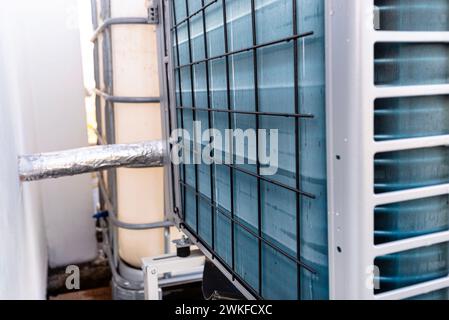 Unité extérieure d'une pompe à chaleur à air de faible puissance située devant la maison. Banque D'Images