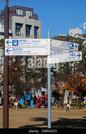 Un panneau de rue piétonne montrant les directions pour la gare de Kannai, Odori Park et plusieurs autres endroits à Yokohama. Banque D'Images