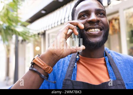 Un Afro-américain parle au téléphone à l'extérieur Banque D'Images