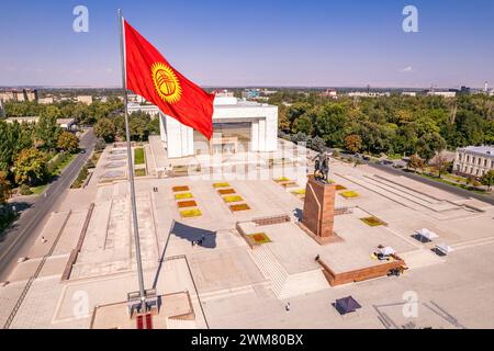 Vue aérienne de dessus au drapeau Kirghizistan. Monument statue épique d'Aykol Manas - héros kirghize sur la place Ala-Too. Musée d'histoire de l'État dans le centre-ville de Bichkek c Banque D'Images