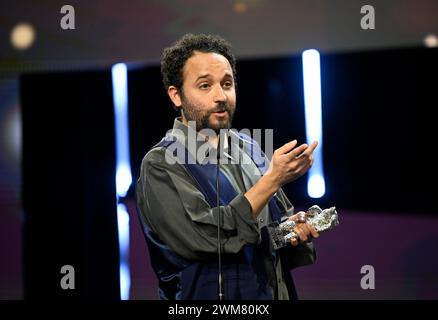 Berlin, Allemagne. 24 février 2024. Le réalisateur Nelson Carlos de Los Santos Arias se tient sur scène lors de la cérémonie de remise des prix lors du gala de clôture au Palast de la Berlinale après avoir remporté un Ours d'argent dans la catégorie meilleur réalisateur pour le film 'Pepe'. Le 74ème Festival International du film de Berlin aura lieu du 15 au 25 février 2024. Crédit : Monika Skolimowska/dpa/Alamy Live News Banque D'Images