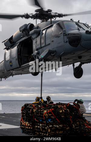 OCÉAN PACIFIQUE (23 février 2024) les marins affectés au porte-avions d'assaut amphibie déployé à l'avant USS America (LHA 6) et les Marines affectés à la 31e Marine Expeditionary Unit (MEU), effectuent un réapprovisionnement vertical avec le cargo USNS Carl Brashear (T-AKE-7) tout en menant des opérations de routine dans l'océan Pacifique, le 23 février. America, navire chef de file de l'America Amphibious Ready Group, opère dans la zone d'opérations de la 7e flotte américaine. La 7e flotte américaine est la plus grande flotte numérotée déployée vers l’avant de l’US Navy, et interagit et opère régulièrement avec des alliés et des partenaires en preser Banque D'Images