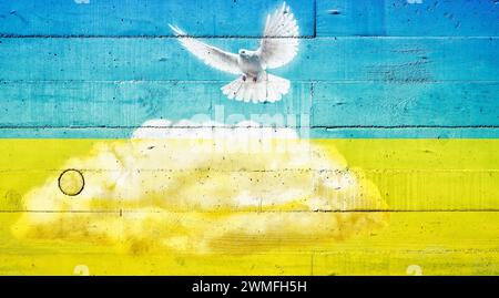 Colombe de paix sur un mur de béton aux couleurs du drapeau ukrainien Banque D'Images