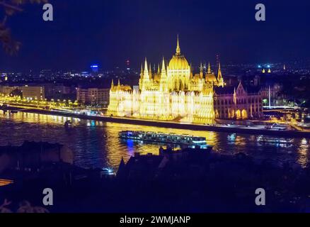 Fantastique bâtiment du Parlement hongrois dans l'illumination de nuit, une grande et petite voile de bateaux à voile à proximité, vue de Buda côté de la ville Budapest, Banque D'Images