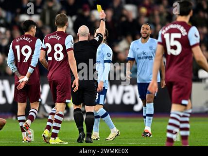 Londres, Royaume-Uni. 26 février 2024. Simon Hooper (arbitre) montre le carton jaune à Zanka (Brentford, 2e à droite) lors du match de West Ham vs Brentford premier League au London Stadium Stratford. Cette image est RÉSERVÉE à UN USAGE ÉDITORIAL. Licence exigée du Football DataCo pour toute autre utilisation. Crédit : MARTIN DALTON/Alamy Live News Banque D'Images