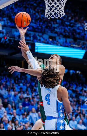 Chapel Hill, Caroline du Nord, États-Unis. 26 février 2024. Caroline du Nord Tar Heels garde RJ Davis (4) fautes Miami (FL) Hurricanes garde Matthew Cleveland (0) alors qu'il tire dans le match de basket ACC au Dean Smith Center à Chapel Hill, NC. (Scott Kinser/CSM). Crédit : csm/Alamy Live News Banque D'Images