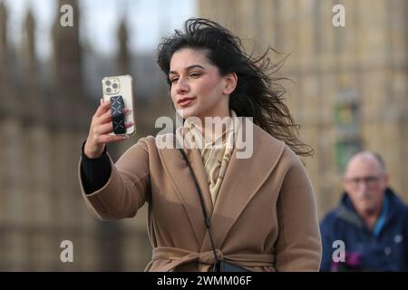 Londres, Royaume-Uni. 26 février 2024. Une femme prend des selfies dans le centre de Londres. Les téléphones portables sont devenus un outil indispensable dans la vie quotidienne des gens. Crédit : SOPA images Limited/Alamy Live News Banque D'Images