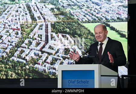 Fribourg, Allemagne. 27 février 2024. Le chancelier fédéral Olaf Scholz (SPD) parle devant une image informatique du projet de construction lors d'une cérémonie inaugurale pour le grand nouveau quartier de Dietenbach à Fribourg. Crédit : Bernd Weißbrod/dpa/Alamy Live News Banque D'Images