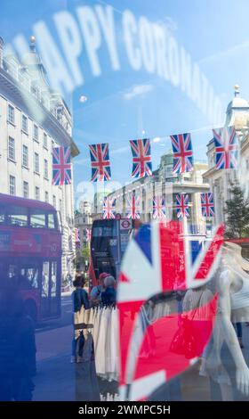 Les drapeaux de l'Union se reflètent dans les décorations des vitrines de Regent Street alors que Londres se prépare au couronnement du roi Charles III Banque D'Images