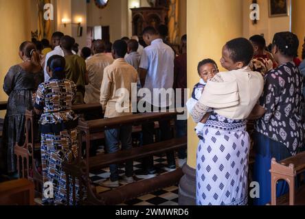 Une mère de la congrégation câlin son bébé à la messe catholique du dimanche dans la cathédrale Saint-Joseph, Stone Town, Zanzibar, Tanzanie Banque D'Images