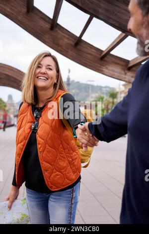 Heureux couple caucasien d'âge moyen dans l'amour se tenant par la main regarder les uns les autres en profitant ensemble d'un voyage. Banque D'Images