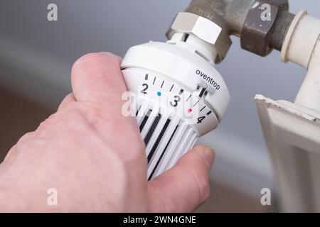 Hand on a radiator valve Stock Photo