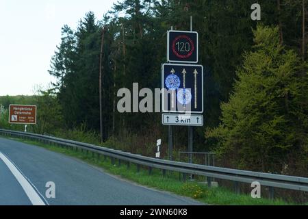 Un panneau de signalisation rectangulaire noir et blanc se dresse sur le côté d'une route, fournissant des indications et des informations aux conducteurs et aux piétons qui passent. Banque D'Images