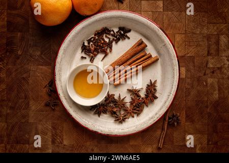 Une vue de dessus d'une planche de bois avec des ingrédients pour le vin chaud sur une table Banque D'Images