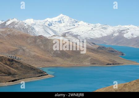 Montagnes enneigées derrière le lac Yamdrok au Tibet Banque D'Images