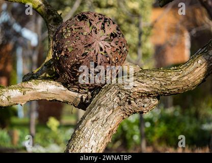 Élément ornemental en métal dans l'arbre, jardin Shepherd House, Inveresk, East Lothian, Écosse, ROYAUME-UNI Banque D'Images