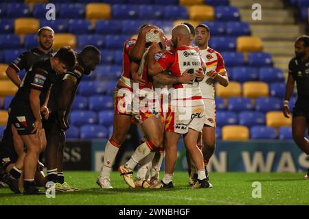 London, UK. 25th Feb, 2024. Theo Fages of Catalan Dragons scores a try to make the score 0-14 and is congratulated during the Super League match between London Broncos and Catalan Dragons at Plough Lane, London, England on 23 February 2024. Photo by Ken Sparks. Editorial use only, license required for commercial use. No use in betting, games or a single club/league/player publications. Credit: UK Sports Pics Ltd/Alamy Live News Stock Photo