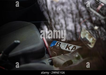 Ein Kennzeichen ohne Plakette liegt im Fussraum. Ein teilweise zerstörtes, nicht angemeldetes, Auto steht ohne Kennzeichen auf einem öffentlichen Parkplatz AM 01. März 2024 BEI Großbeeren dans le Brandebourg. Kaputtes Auto *** Une plaque d'immatriculation sans autocollant se trouve dans le plancher Une voiture partiellement détruite, non immatriculée se trouve sans plaque d'immatriculation dans un parking public le 01 mars 2024 près de Großbeeren dans le Brandebourg voiture cassée Banque D'Images