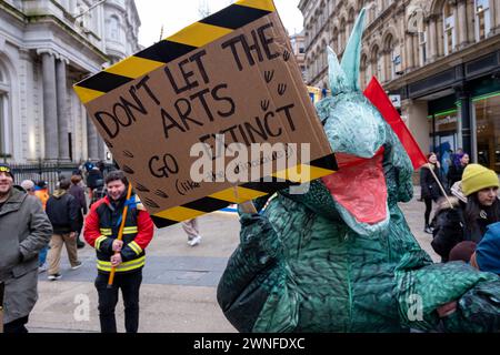Les manifestants déguisés en dinosaures contre les coupures dans les arts lors de la manifestation "Stand Up for public services" contre les coupures du conseil municipal de Birmingham le 2 mars 2024 à Birmingham, au Royaume-Uni. La manifestation a appelé les résidents, les travailleurs et les syndicats de toute la ville à se rassembler contre les compressions dévastatrices du conseil municipal, qui s'élèvent actuellement à environ 376 millions de livres sterling pour les services, ce qui est susceptible d'avoir un impact majeur sur les résidents. Parmi les domaines cités comme sujets à des réductions figurent les services pour la jeunesse, les transports, la collecte des ordures, les bibliothèques et les organisations artistiques. Le conseil travailliste a eu de longue date f Banque D'Images