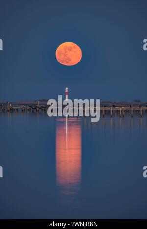 Lever la pleine lune au-dessus du phare de Fangar dans le delta de l'Èbre (Tarragone, Catalogne, Espagne) ESP : Salida de la Luna llena sobre el faro del Fangar Banque D'Images