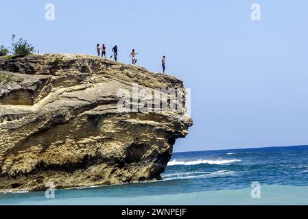 Bronzer, explorer les formations rocheuses, surfer et plonger depuis les falaises le long de Poipu Beach sur l'île de Kauai à Hawaï. Banque D'Images