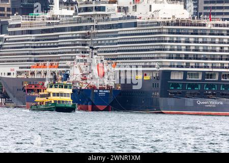 Navire de croisière Queen Victoria à Circular Quay soutenu par ICS Reliance navire de ravitaillement en mazout, ferry passant par la poupe, Sydney, Australie Banque D'Images