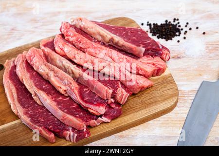 gros plan de morceaux de bœuf marbré sur une table en bois Banque D'Images