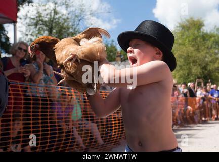 06/08/16 ***AVEC LA VIDÉO*** Brody Wordsworth, 6 ans, peine à tenir sa poule avant le début de la première manche.. Les foules encouragent les poules en compétition Banque D'Images