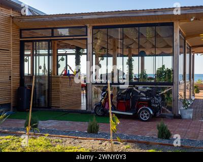 Petite voiture électronique pour le parc. Voiturette de golf. Véhicule stationné. Extérieur d'un restaurant sur la plage. Resort Banque D'Images