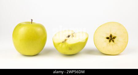 Pommes jaunes, un tout et deux moitiés de pommes sur fond blanc, bannière Apple pour votre économiseur d'écran ou votre projet. Banque D'Images