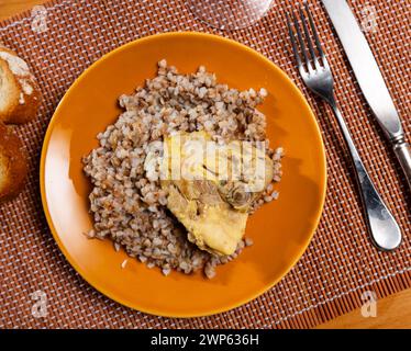 Sarrasin bouilli dans un bol avec cuisses de poulet. Table de dîner, concept de nourriture saine Banque D'Images