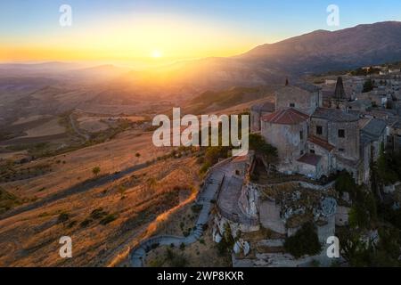 Vue aérienne de l'ancienne ville de Petralia Soprana, construite sur une falaise, au coucher du soleil. Palerme district, Sicile, Italie. Banque D'Images