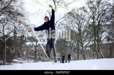 05/02/13 Matt Stevens, 19 ans, pratique la slackline à travers une ligne tendue entre les arbres à Buxton, Derbyshire lors de fortes chutes de neige. 'La neige donne un s. Banque D'Images