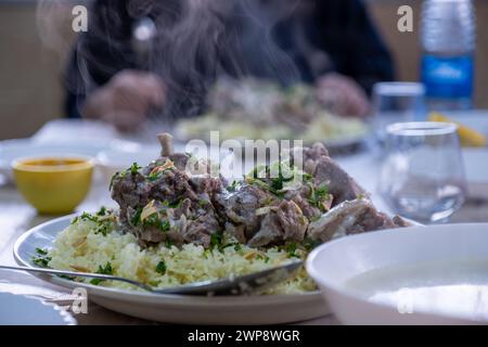 vapeur de mansaf fraîche chaude avec les mains autour de lui prêt à être mangé sur la table familiale pour iftar Banque D'Images