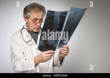 Médecin praticien en robe médicale rétro traditionnelle déterminant la maladie Banque D'Images